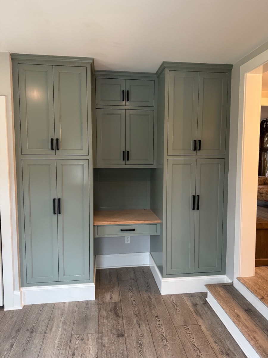 Custom sage green pantry with built-in desk nook
